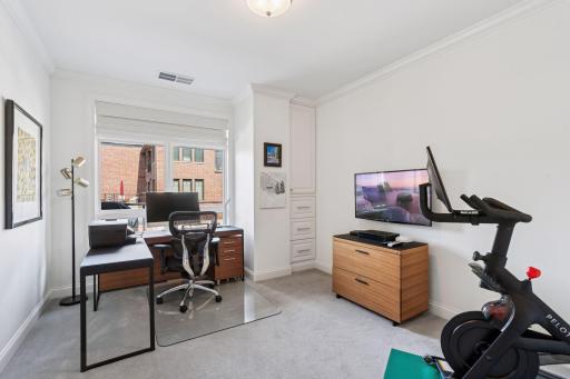 The condo's 2nd bedroom is currently being used as a home office space