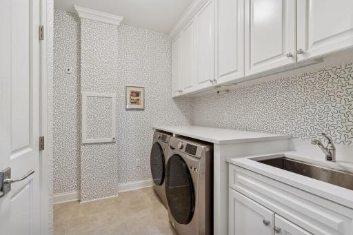 Spacious laundry room with great storage space and sink