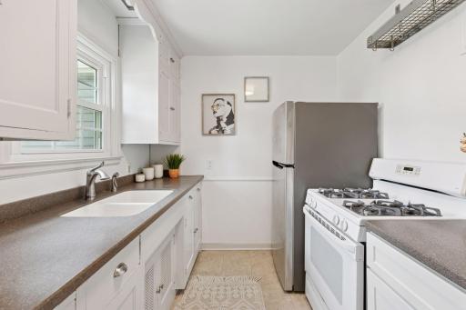 Gas range stove, stainless steel fridge, and easy access to both the backyard patio, and informal dining.