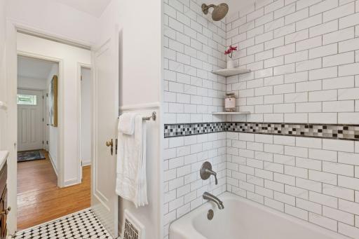 Tile surround shower with custom built-in shelves.