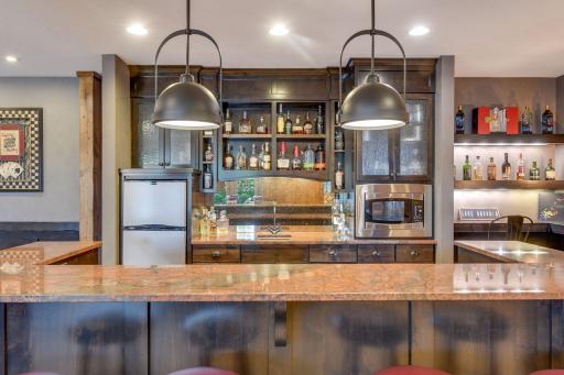 The bar features granite counters with pullout shelves and soft close drawers.