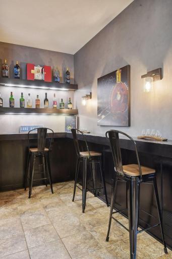 This alcove is perfect with extra shelves for your collection and counter seating for guests