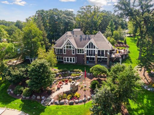 Professionally landscaped by By the Yard - a - this home is a showstopper from the lake.