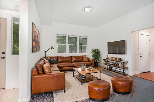 Main floor living room with windows overlooking Lawson Ave