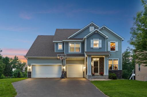 From the moment you step inside, this is not your average two-story walkout — it’s a home that impresses at every turn with remarkable views of Lake Riley right from your backyard.