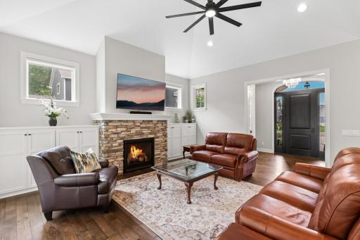 Cozy fireplace surrounded by built in storage.