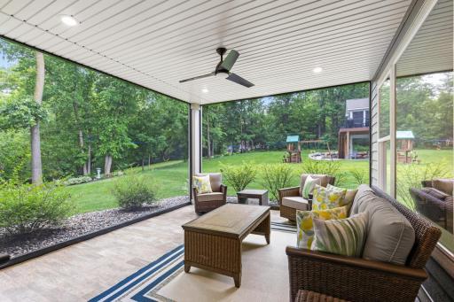 Professionally finished screened-in porch with tiled flooringâenjoy the outdoors in comfort and style.