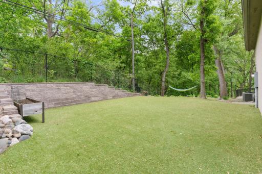 Astro-turf located on the side of the home for comfortable play area