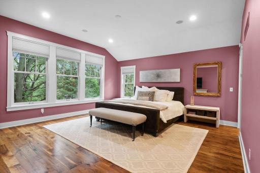 Primary suite boasts rich hardwood flooring