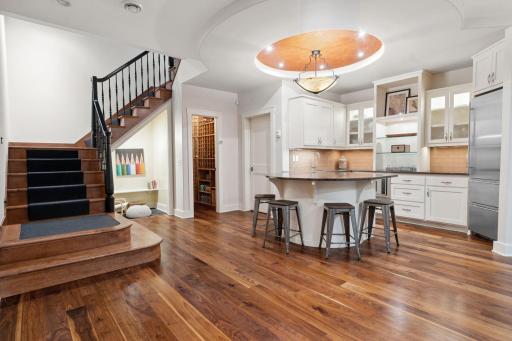 Lower level has full kitchen, center island & wood floors, with walkout to the backyard