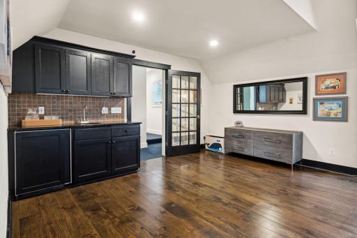 Flex room includes wet bar and wood floors