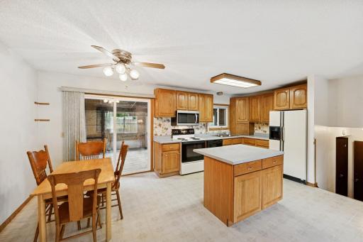 Large kitchen with center island, and walks out to newly remodeled three season porch.