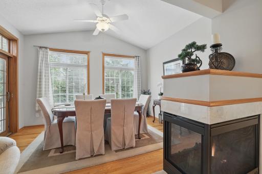 3 sided fireplace separates living room from the sun room