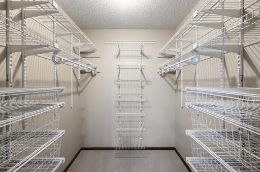 6' x 6.5' primary bedroom walk-in closet with built-in storage system.