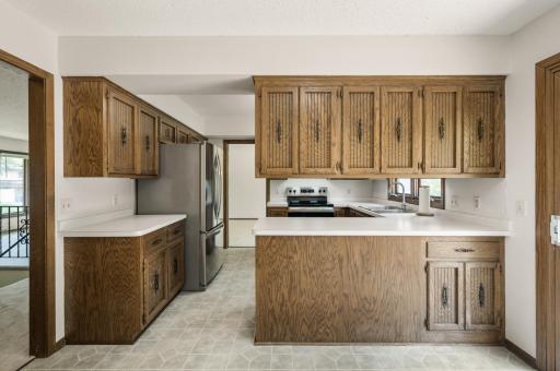 Keep the kitchen as-is or remove some upper cabinets for a more open feel.