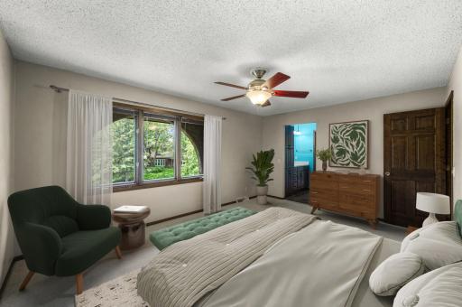 Primary bedroom with ensuite bathroom and walk-in closet. (virtually staged)
