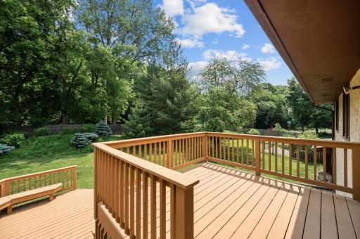 Two-tired deck overlooks the fully fenced-in private and landscaped backyard.