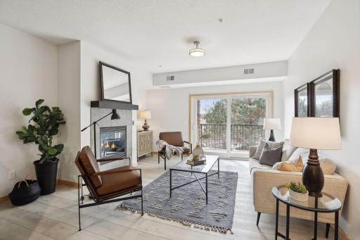 Beautiful living room with gas fireplace, new surround. Patio doors provide lots of natural light