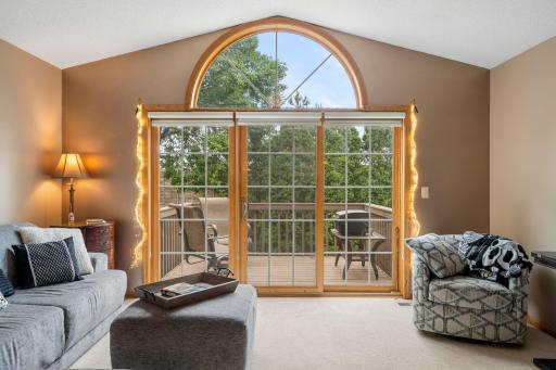 A large picture window is fitted with dual zebra shades, allowing you to easily adjust the natural light to your preference. A sliding glass door leads directly to a 10x8 deck—perfect for entertaining or relaxing.
