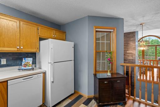 Another view of the kitchen showcasing the brand-new refrigerator and dishwasher.