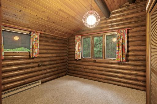 The second upper level bedroom also has plush carpet and abundant natural light streaming through the dual windows.