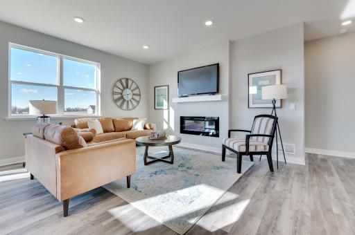 This spacious family gathering area seamlessly connects to the kitchen area, perfect for entertaining. It also features many large windows providing warm natural light. *Pictures are of a similar model home, actual colors and finishes may vary.