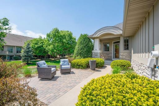 A beautiful custom stone patio greets you as you enter the home