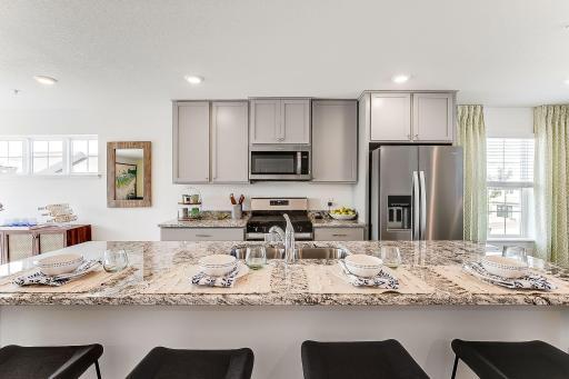With a gas range, vented microwave fan, and large entertaining island, this kitchen is a chef's dream! *Model home, colors and selections will vary.