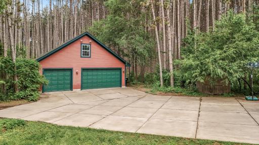 Detached 3 car garage with finished workroom and unfinished bonus room above!