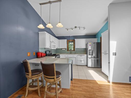 The kitchen features a tiled floor and a peninsula that makes for a great breakfast bar.