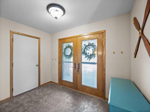 The welcoming foyer features a stamped concrete floor that extends to the living room and includes in-floor heat.
