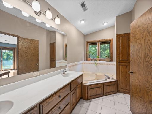 The primary bathroom features double sinks and a separate tub and shower.