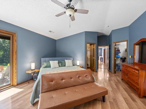 The primary bedroom offers access to the concrete patio in the backyard.
