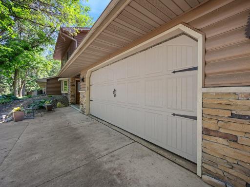 This home features brick accents and vinyl faux-log siding.