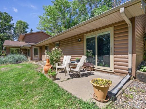 The backyard patio offers extra space to sit and enjoy the green space this property offers.