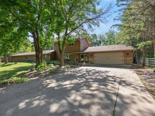 The concrete driveway leads up to the oversized garage.