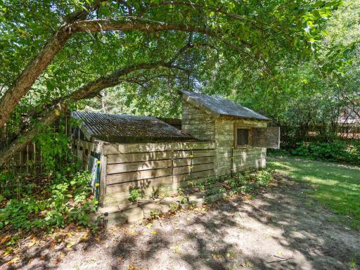 The backyard includes a chicken coop.