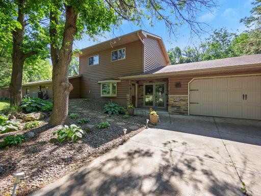 The concrete driveway leads up to the oversized garage.
