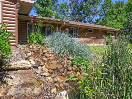 The backyard landscaping includes stunning water features.