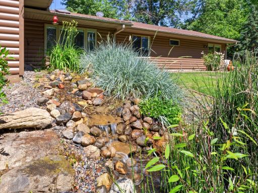 The backyard landscaping includes stunning water features.