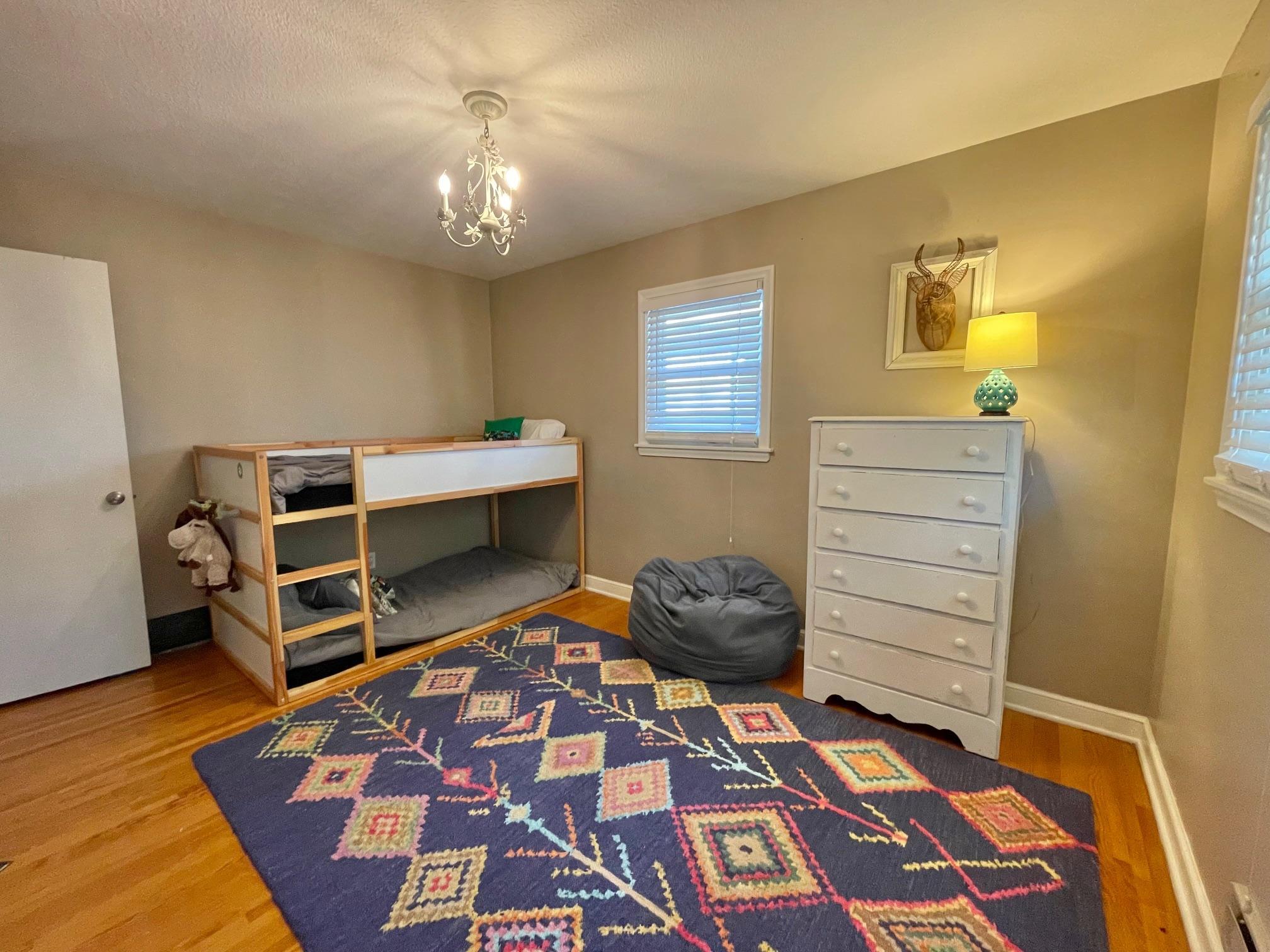 Bedroom 2 on main floor has hardwood flooring.