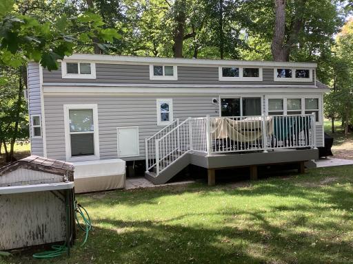 View of deck and 1 1/2 story home