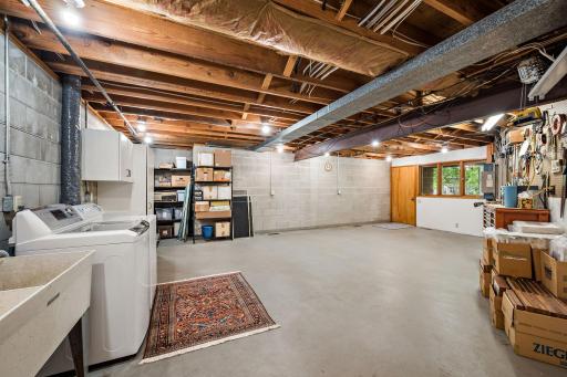 Massive storage area with laundry below flex room/studio walks out to backyard.