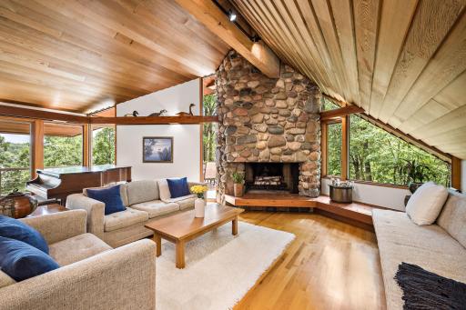 Vaulted Wood Ceilings and a Striking Stone Fireplace create warmth and character