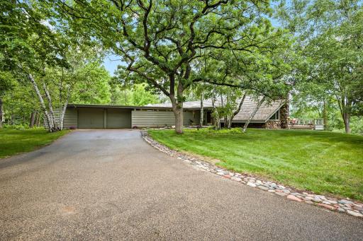 One of the most unique properties in the Twin Cities set on nearly 2 acres overlooking a tranquil nature lake in Eagan!