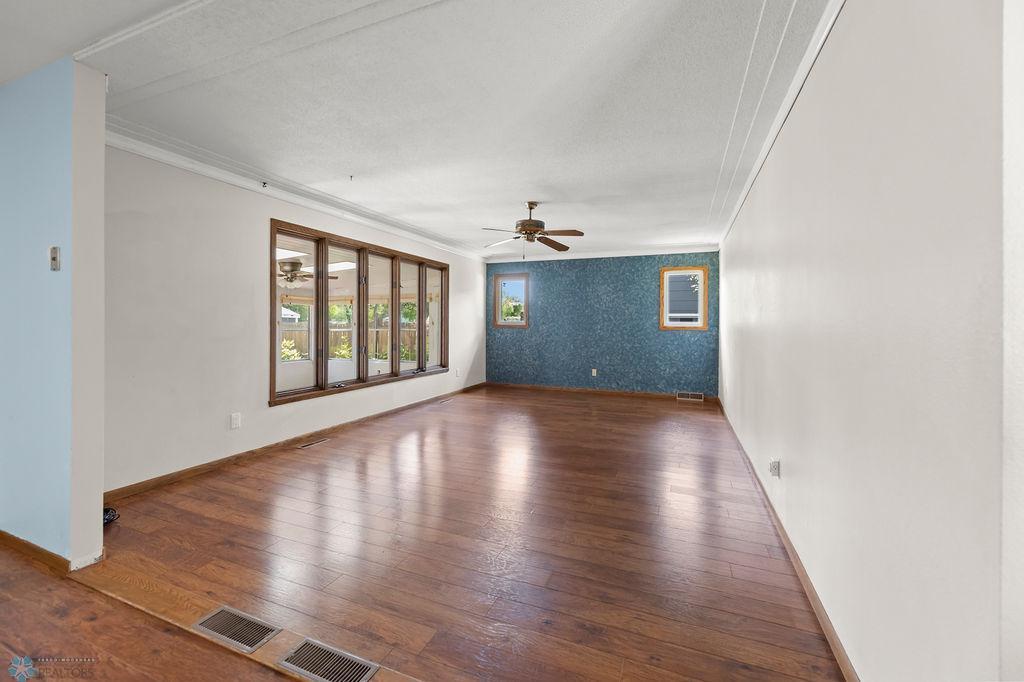 Living Room. Large windows, ceiling fan, accented ceiling.