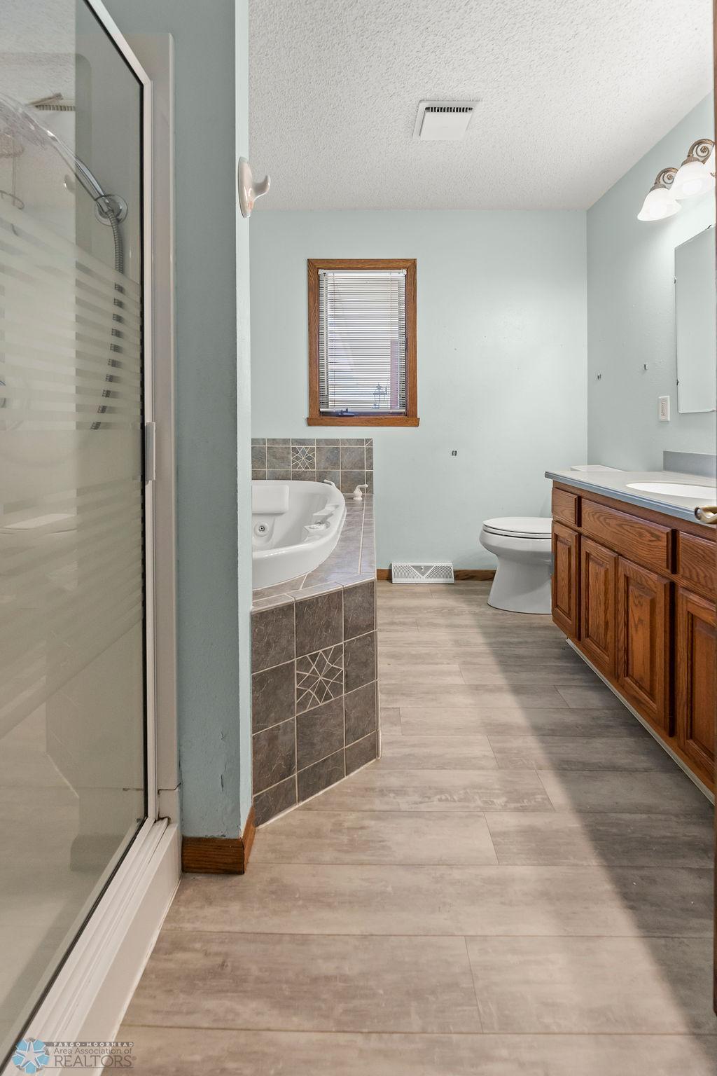 Main level Full Bathroom. 4-piece bath w/ jet tub & walk-in shower.