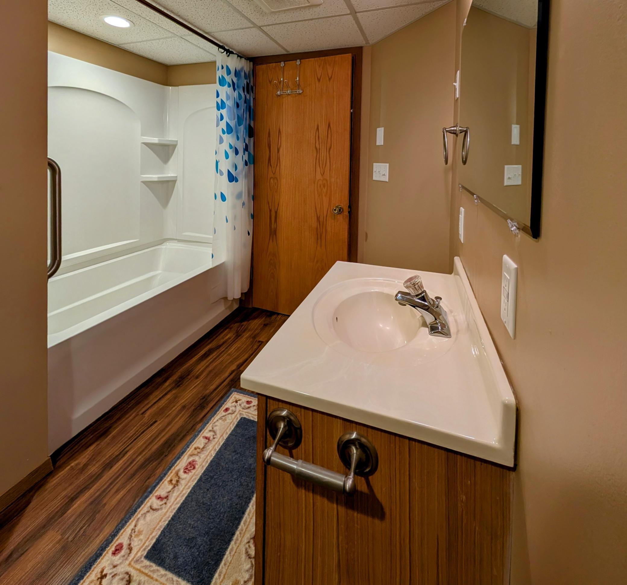 Nicely finished LL full bath also features seamless tub/shower.