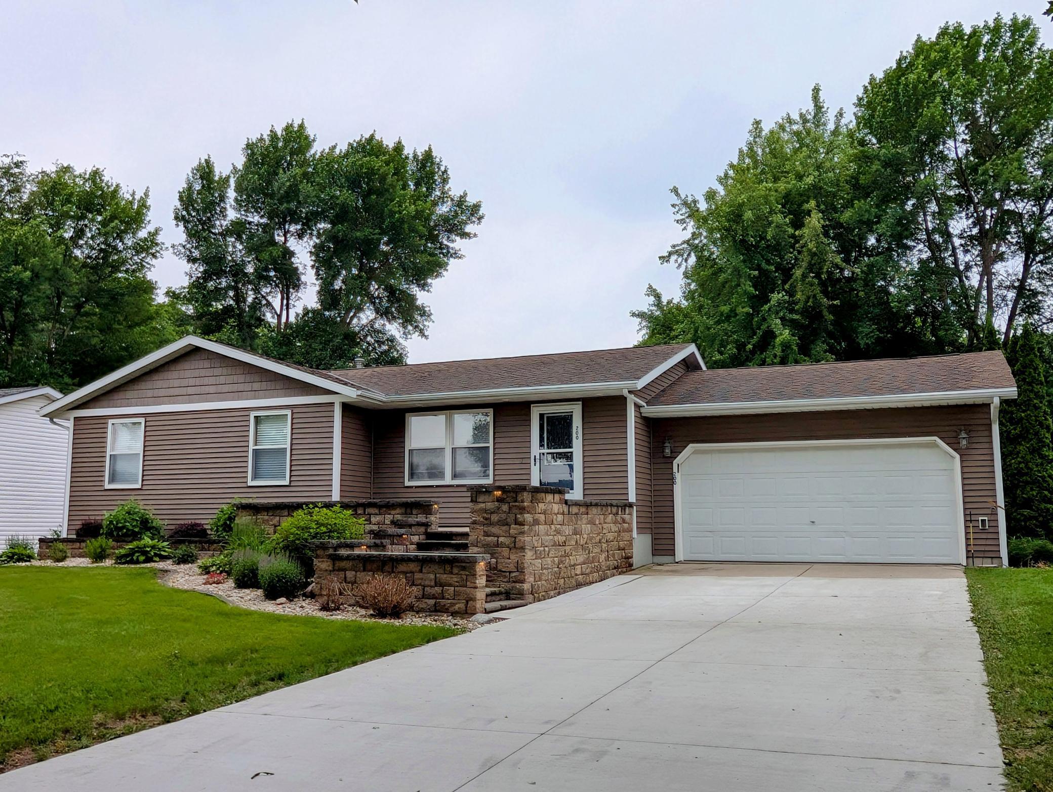 Gorgeous curb appeal with custom front entry and established perennials.