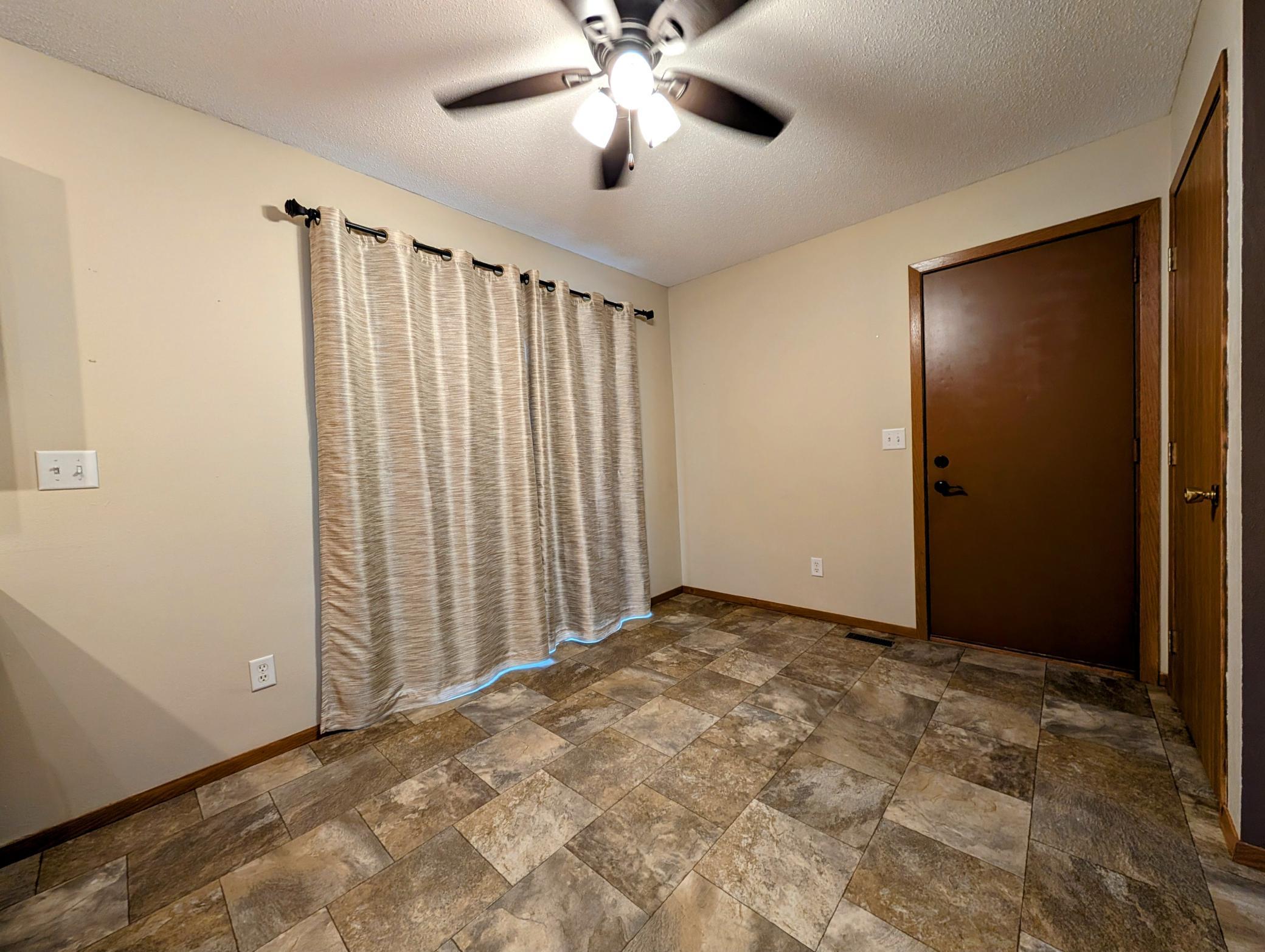 The dining area features sliding glass door to deck, accessing pristine back yard.